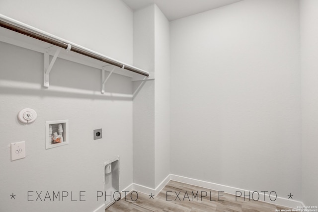 laundry area with hookup for a gas dryer, hardwood / wood-style flooring, washer hookup, and electric dryer hookup