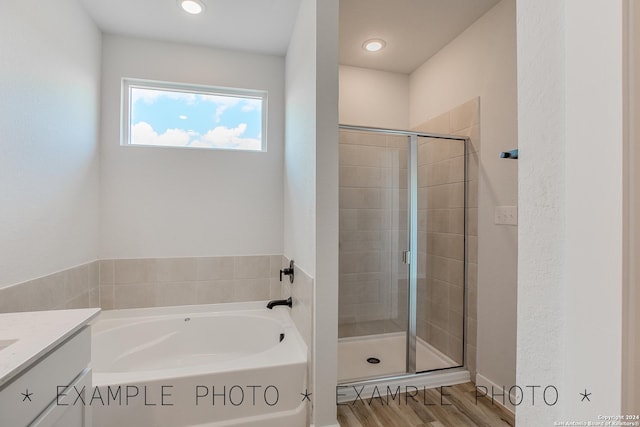 bathroom featuring vanity, hardwood / wood-style flooring, and independent shower and bath