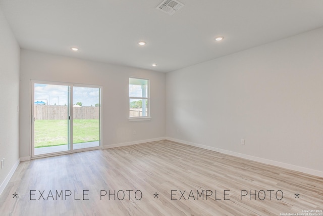 spare room featuring light hardwood / wood-style flooring