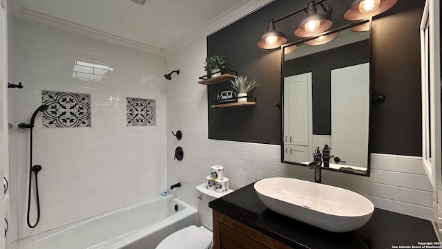 full bathroom featuring vanity, crown molding, tiled shower / bath combo, and toilet