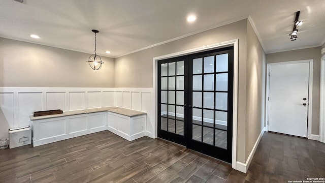 interior space featuring crown molding, rail lighting, french doors, and dark hardwood / wood-style flooring