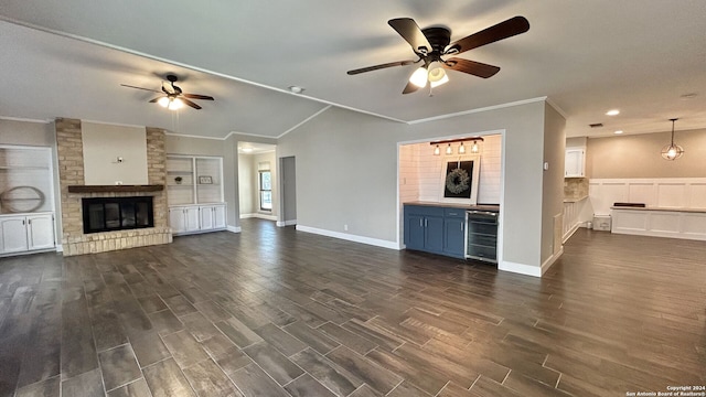 unfurnished living room with wine cooler, a fireplace, dark hardwood / wood-style floors, and ceiling fan