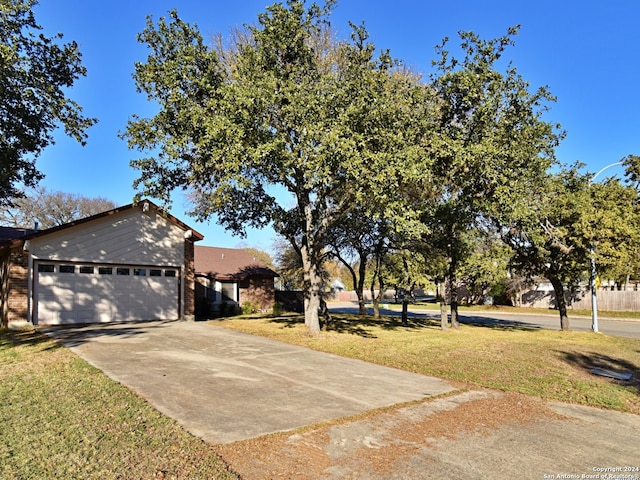 view of front of property with a garage and a front lawn