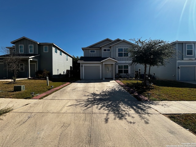 view of front property featuring a front yard and a garage