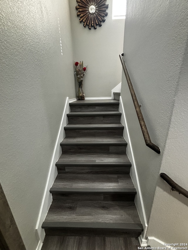 stairway featuring hardwood / wood-style flooring