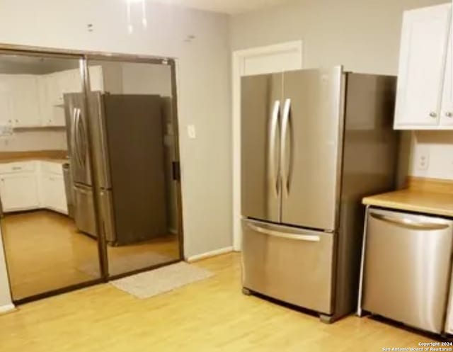 kitchen featuring white cabinetry, stainless steel appliances, and light hardwood / wood-style flooring