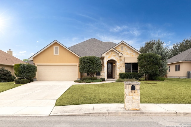 view of front of property featuring a front yard, a garage, and cooling unit