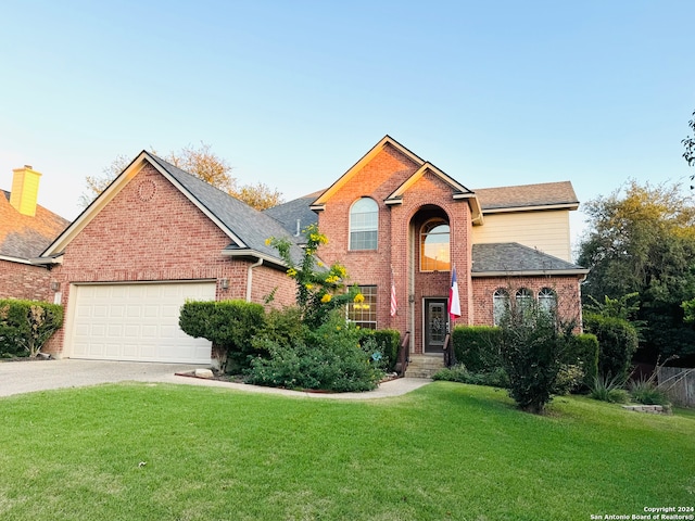 front facade with a garage and a front yard