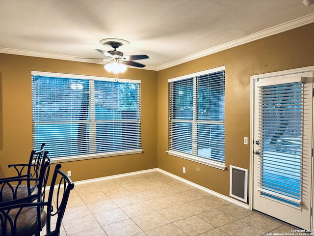 interior space featuring light tile patterned flooring, ceiling fan, and crown molding