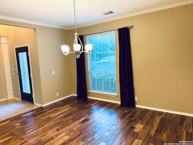 unfurnished room with a chandelier, dark hardwood / wood-style floors, and crown molding