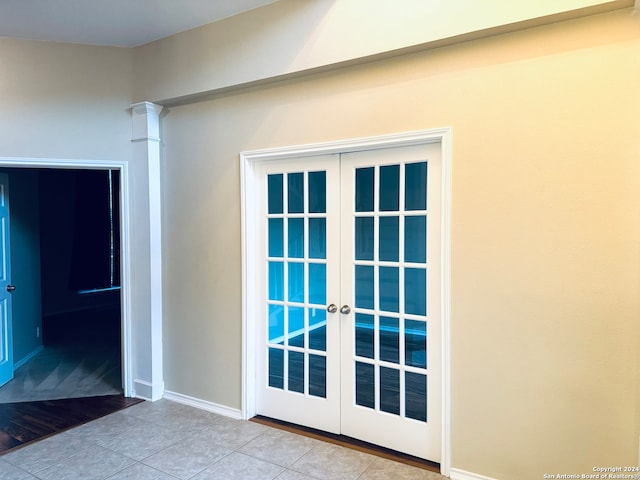 entryway featuring light tile patterned floors and french doors