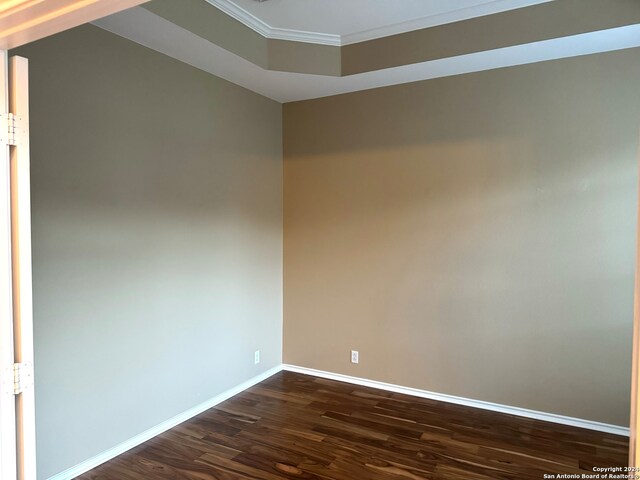 spare room with dark hardwood / wood-style flooring and ornamental molding