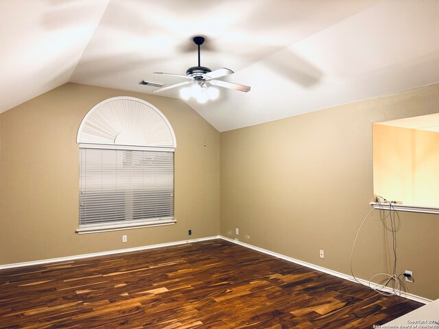 unfurnished room featuring dark wood-type flooring, ceiling fan, and lofted ceiling