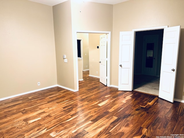 unfurnished bedroom with dark hardwood / wood-style floors