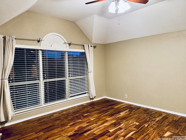 empty room with hardwood / wood-style floors, ceiling fan, and lofted ceiling