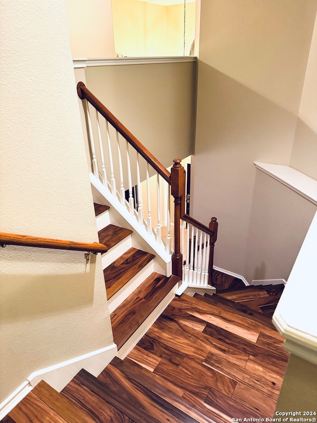 stairs with wood-type flooring