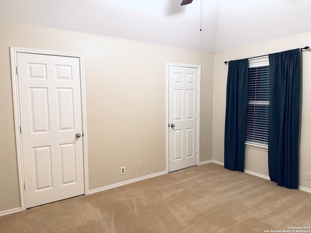 unfurnished room with ceiling fan and light carpet