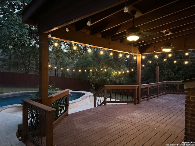 wooden deck with a pool with hot tub and ceiling fan