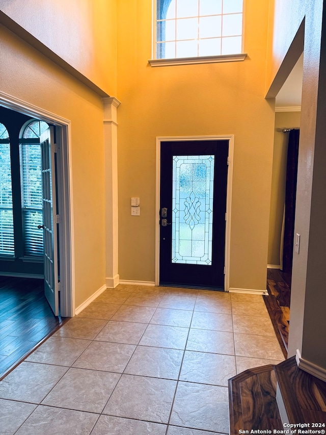 foyer featuring light hardwood / wood-style floors and crown molding