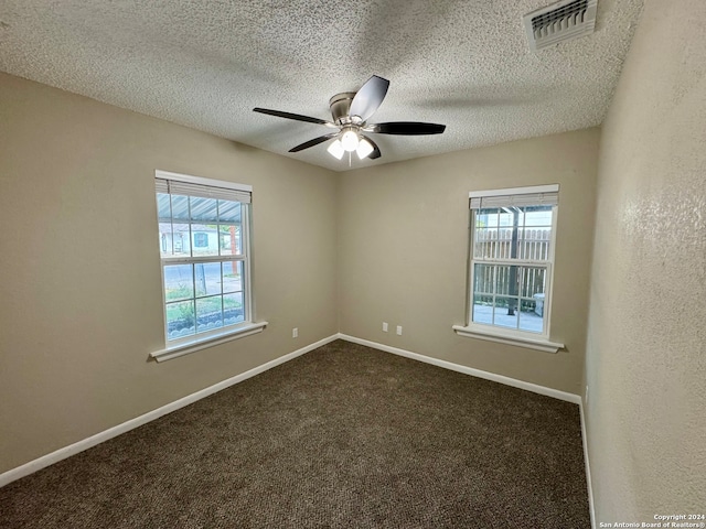 carpeted empty room featuring a textured ceiling and ceiling fan