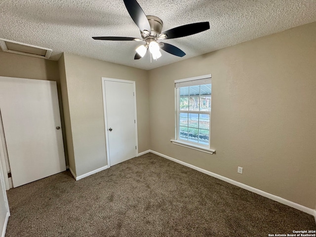 unfurnished bedroom featuring ceiling fan, carpet, and a textured ceiling