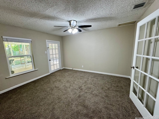 carpeted spare room with french doors, ceiling fan, and a textured ceiling