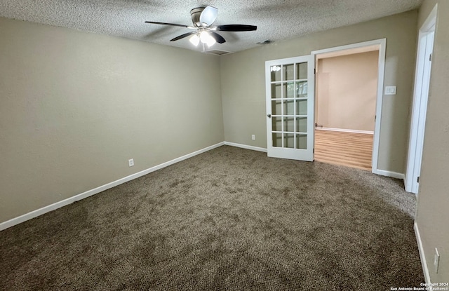 empty room featuring carpet flooring, a textured ceiling, and ceiling fan