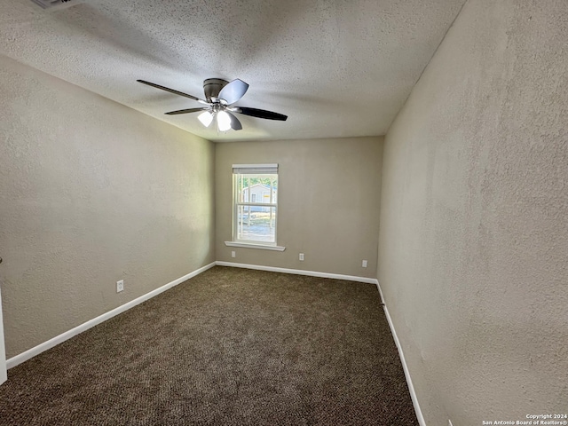 carpeted spare room with ceiling fan and a textured ceiling