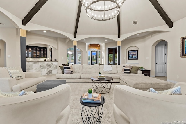 living room featuring beam ceiling, a notable chandelier, and high vaulted ceiling