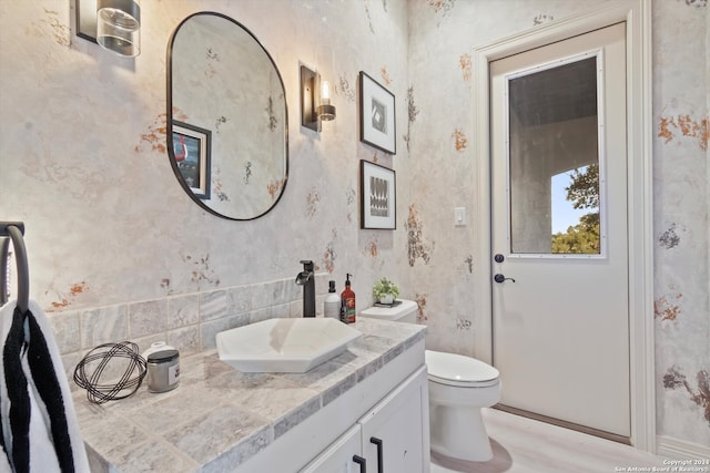 bathroom with vanity, hardwood / wood-style floors, and toilet