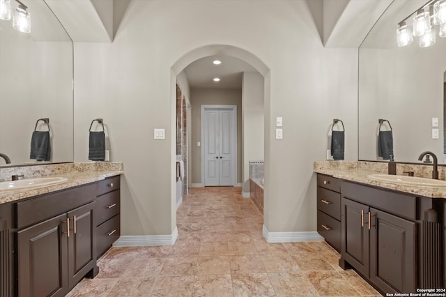 bathroom featuring vanity and a washtub