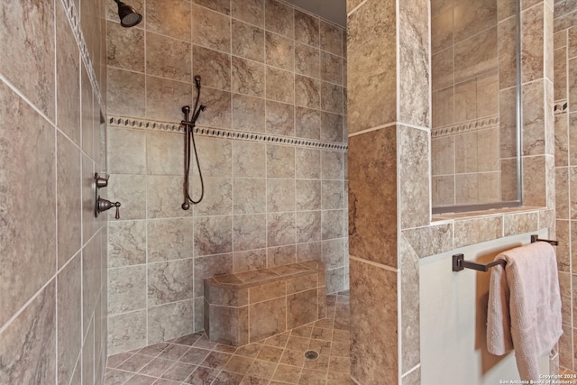 bathroom with tile patterned flooring and tiled shower