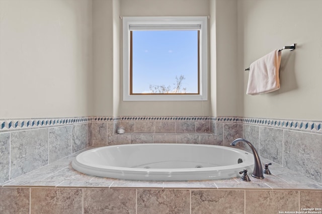 bathroom with tiled bath