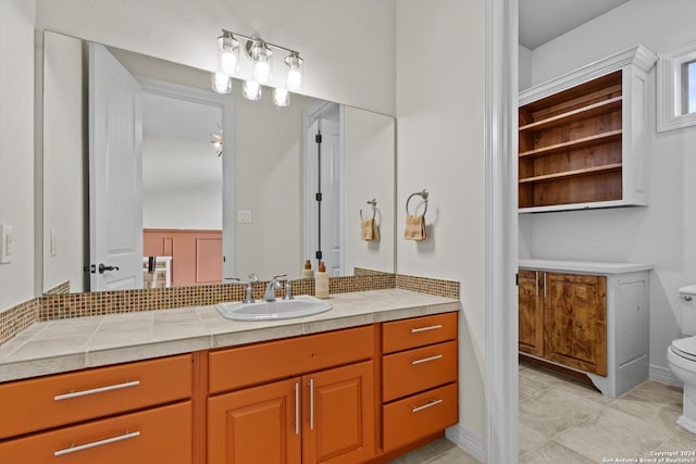 bathroom featuring toilet, vanity, and tile patterned flooring