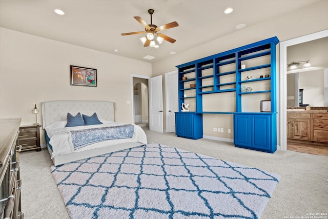 bedroom featuring carpet floors, connected bathroom, and ceiling fan