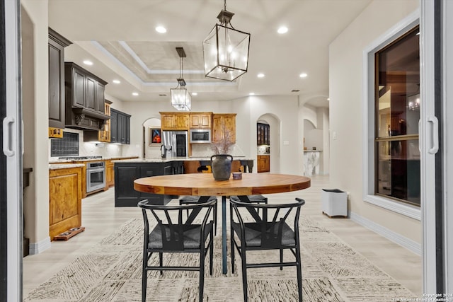 dining room featuring a raised ceiling