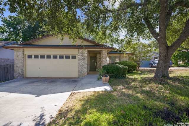 view of front facade with a front yard and a garage