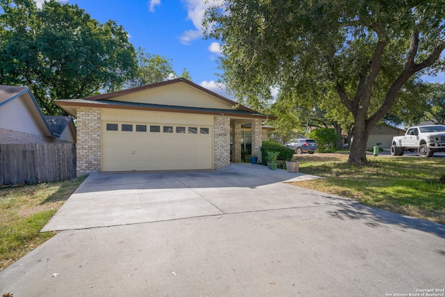 view of front of house with a front yard and a garage