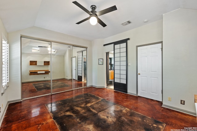 unfurnished bedroom featuring multiple windows, a closet, vaulted ceiling, and ceiling fan