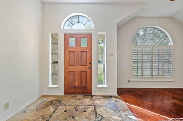 entrance foyer with lofted ceiling and plenty of natural light