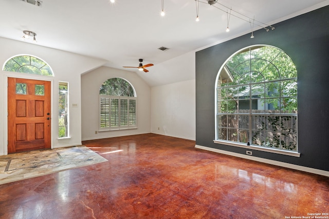 entryway featuring lofted ceiling, rail lighting, concrete flooring, and ceiling fan