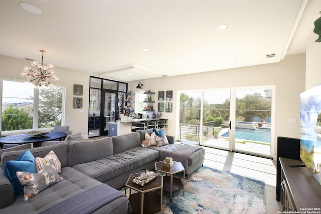 living room featuring a notable chandelier and wood-type flooring