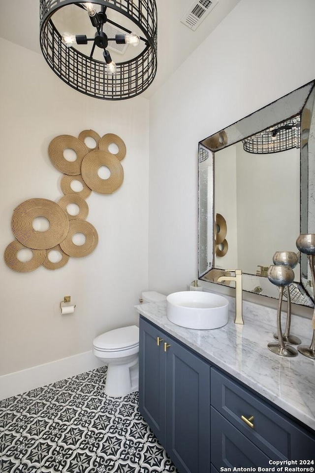 bathroom featuring vanity, ceiling fan, tile patterned flooring, and toilet