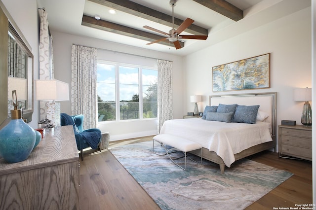 bedroom featuring beam ceiling, dark wood-type flooring, and ceiling fan