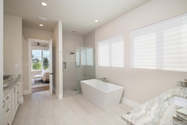 bathroom featuring vanity, ceiling fan, and separate shower and tub