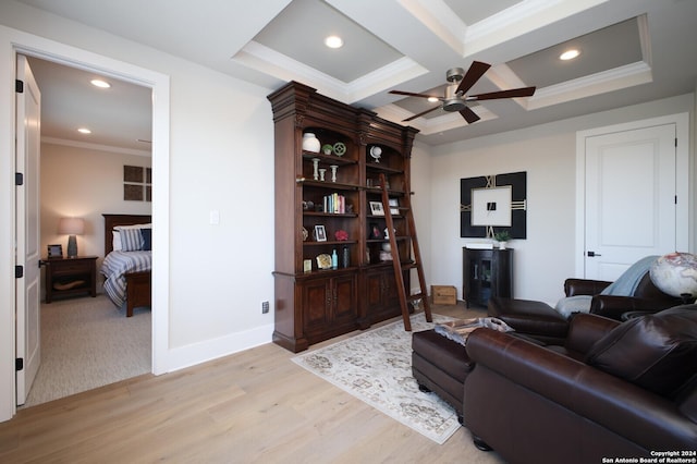 living room featuring coffered ceiling, crown molding, ceiling fan, beam ceiling, and light hardwood / wood-style floors