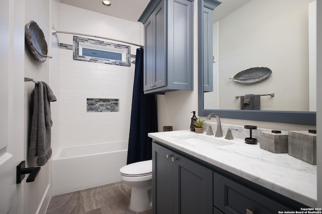 full bathroom with vanity, shower / bath combination with curtain, and toilet