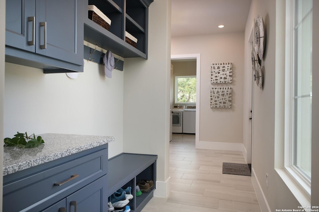 mudroom with independent washer and dryer and light hardwood / wood-style floors