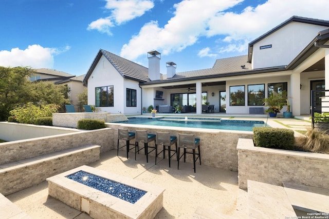 exterior space with a patio, ceiling fan, and a fire pit