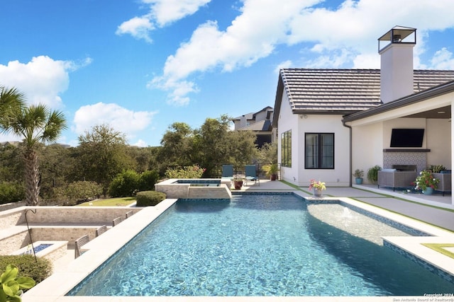 view of swimming pool featuring an in ground hot tub and a patio area